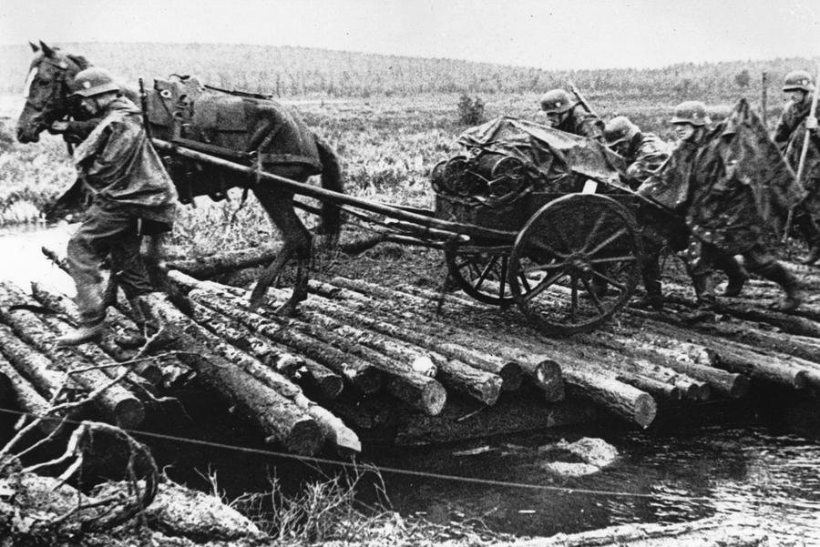 German soldiers move a horse-drawn vehicle 